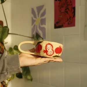 Handmade cup with pomegranates and flowers