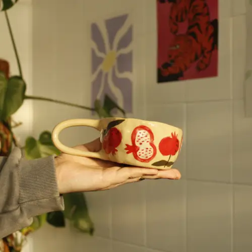 Handmade cup with pomegranates and flowers